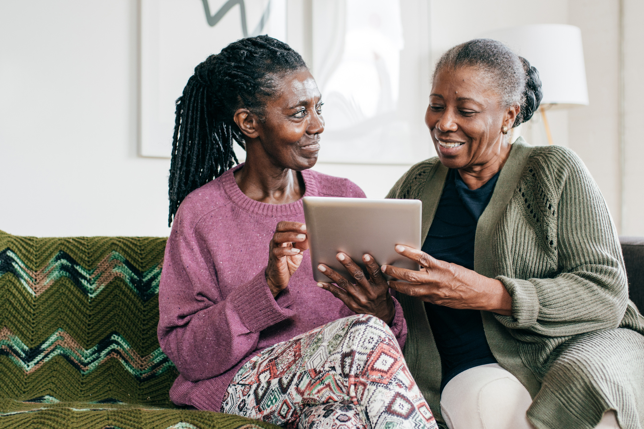 Senior caregiver and senior women with tablet